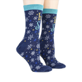 Lifestyle shot showing the 'Let It Snow' socks on a person's feet.