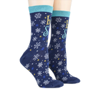 Lifestyle shot showing the 'Let It Snow' socks on a person's feet.