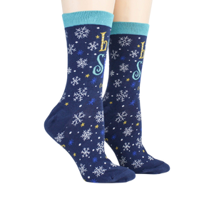 A pair of blue socks with a snowflake pattern and the words 