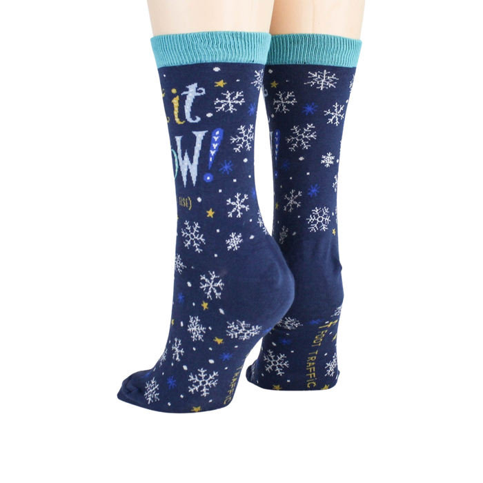 A pair of blue socks with a snowflake pattern and the words 