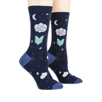 Lifestyle shot showing the socks on a person's feet.  The socks are navy blue with a whimsical design.