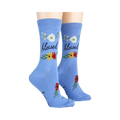 Lifestyle photo showing 'Blessed' socks on a person's feet. The socks are light blue with floral designs.