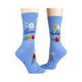 Another lifestyle shot showcasing the 'Blessed' socks; these are light blue with the words 'blessed' and 'thankful' on them.