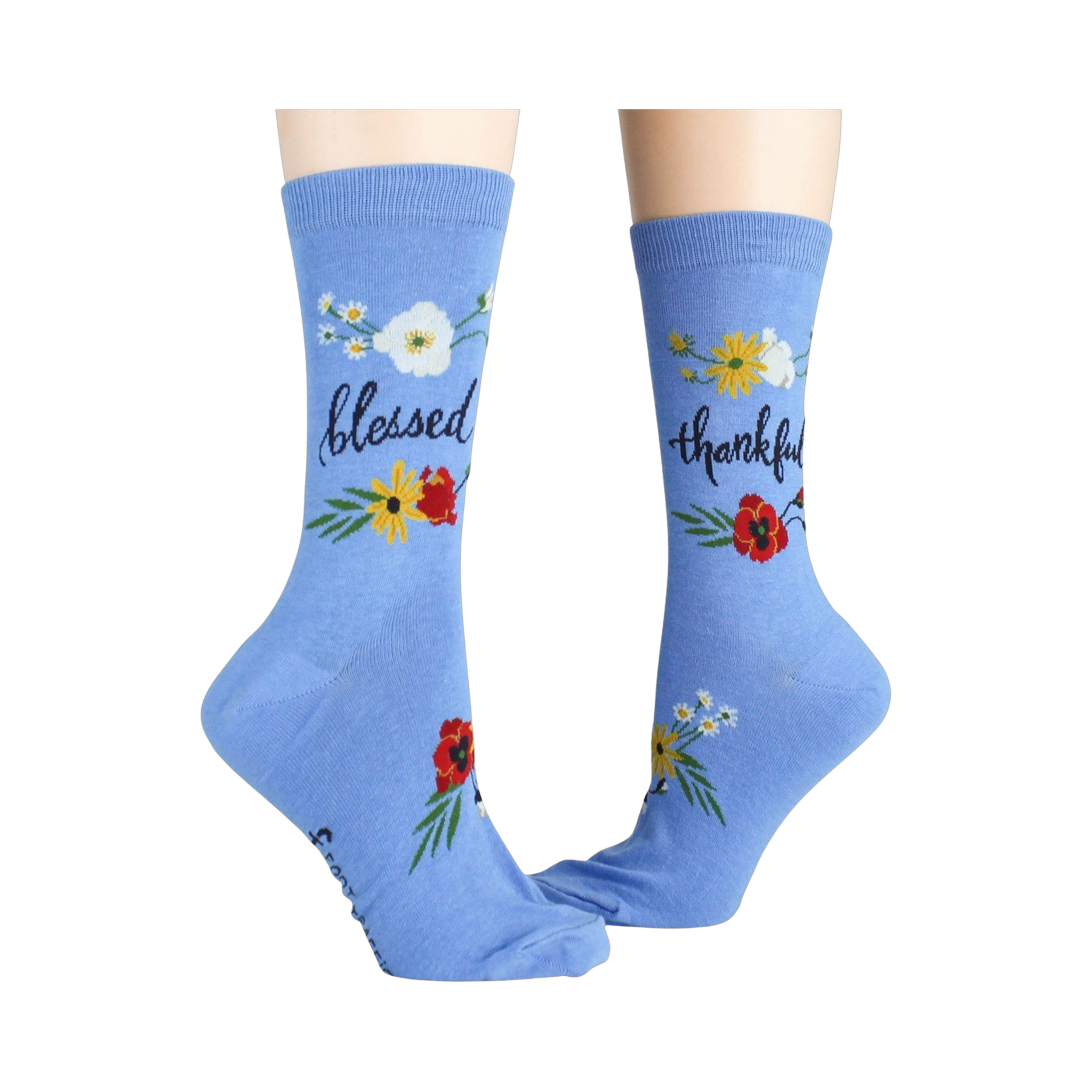 Another lifestyle shot showcasing the 'Blessed' socks; these are light blue with the words 'blessed' and 'thankful' on them.