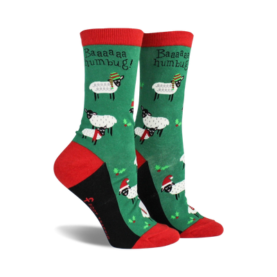 green socks with cartoon sheep wearing santa hats and scarves, 'baa baa humbug!' text.  