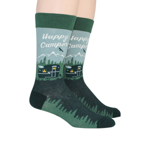 A pair of green socks with a pattern of mountains, trees, and a camper. The words 