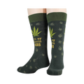 Close-up detail shot of the marijuana leaf and 'It's my favorite herb' text on the socks.