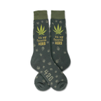 Pair of dark-green crew socks with a repeating cannabis leaf pattern, 'It's my favorite HERB' text, and '420' detail.