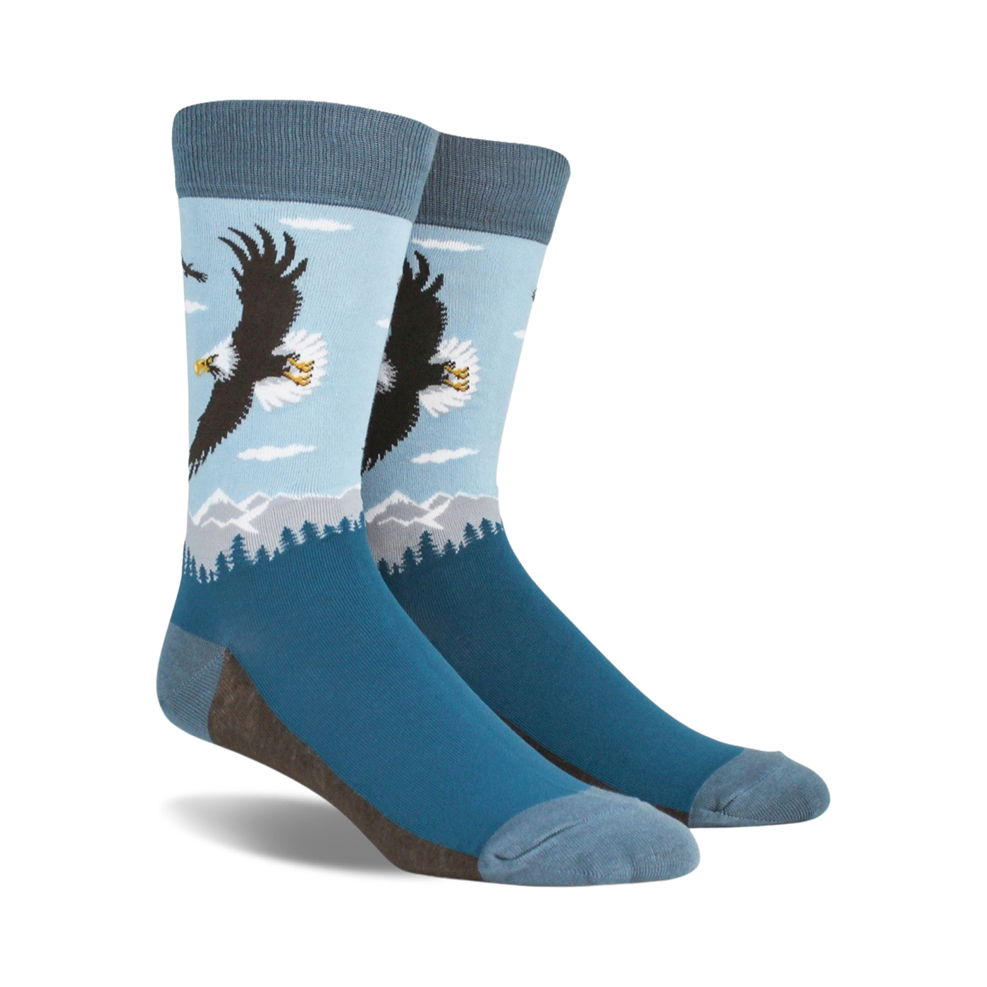 A pair of blue crew socks with a graphic design of a bald eagle soaring over a mountain landscape. 