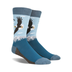 A pair of blue crew socks with a graphic design of a bald eagle soaring over a mountain landscape. 