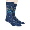 Lifestyle shot showing 'Let It Snow' socks on a person's feet.