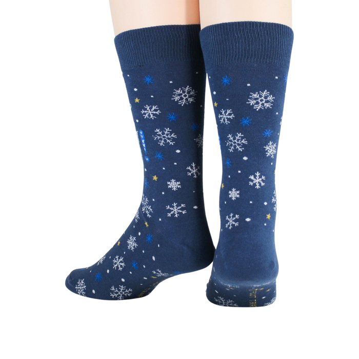 A pair of blue socks with a pattern of snowflakes.