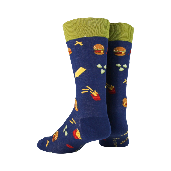 A pair of blue socks with a pattern of burgers, fries, and other food items. The socks have a green cuff.
