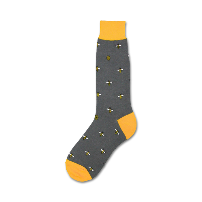 A gray sock with a yellow toe, heel, and cuff. The sock is decorated with a pattern of bees and beehives.