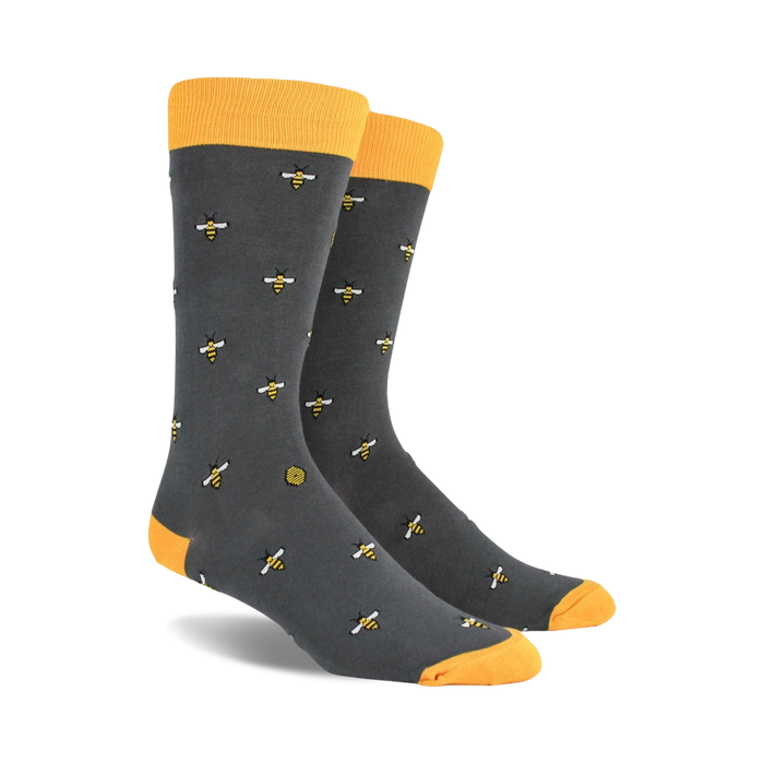 mens yellow crew socks with a buzzing bee and stripe pattern and honeycomb background.  