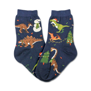 kids christmas tree rex crew socks in dark blue feature holiday dinosaurs in santa hats and christmas lights surrounded by trees and snowflakes.   