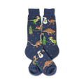Flat lay showcasing the full design of the navy blue crew socks; Christmas dinosaurs and snowmen.
