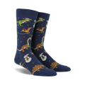 Pair of navy blue crew socks. Feature a whimsical Christmas design with dinosaurs decorating trees and snowmen.