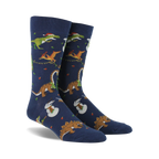 Pair of navy blue crew socks. Feature a whimsical Christmas design with dinosaurs decorating trees and snowmen.