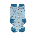 Pair of light blue crew socks with teal cuffs. Features science-themed illustrations: atoms, beakers, DNA strands, and the text 'Believe in Science'.