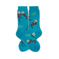 Teal crew socks featuring brown floating sea otters, green kelp, and text reading We need each otter near the toe.