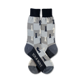 Pair of crew socks in grey and navy blue.  Chessboard pattern features black and white chess pieces.  Text on the socks reads 'Your Move'.