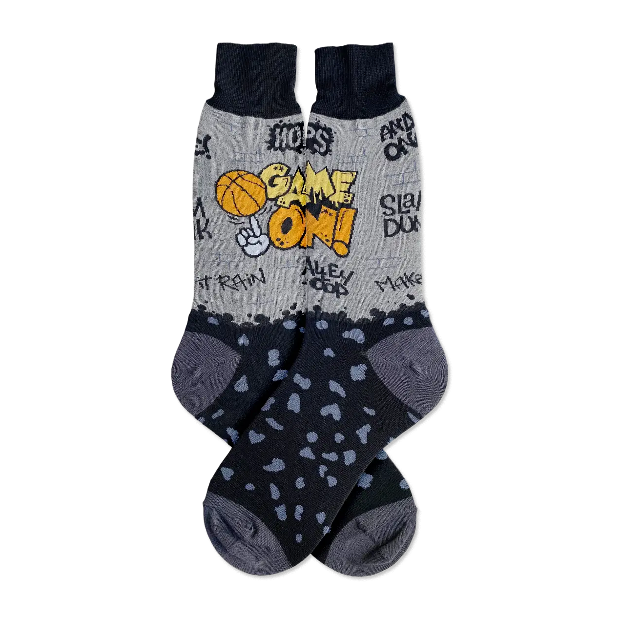 Pair of grey and black crew socks.  The socks feature a basketball graphic, graffiti-style text, and black spots on the lower portion.