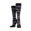 Pair of black crew socks with a white musical note design.  Stylish and fun for music lovers!