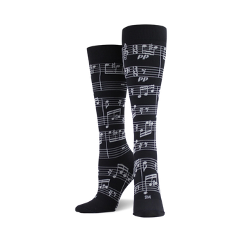 black knee high socks with a pattern of white music notes, made for both men and women.   