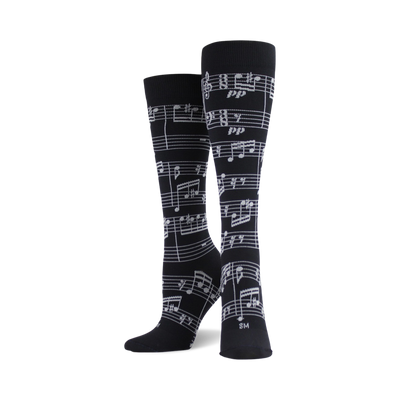 black knee high socks with a pattern of white music notes, made for both men and women.   