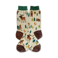 Cream crew socks with brown and green accents. Design features illustrated woodland creatures like moose, bears, Bigfoot, and foxes among stylized evergreen trees.