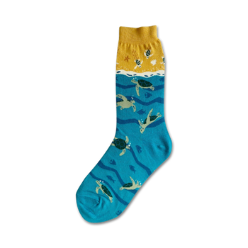 green sea turtles swim through a wavy ocean on these blue crew socks designed for women.  