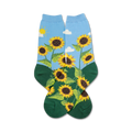 A pair of crew socks with a sunflower design. The socks are mainly light blue with green at the bottom and feature yellow sunflowers and a simple sun and clouds.