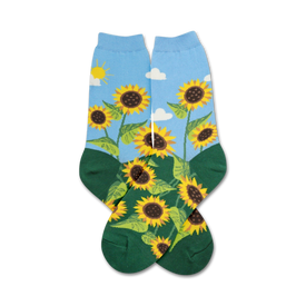 yellow sunflower socks with green leaves. white clouds, a yellow sun on a blue background. green toe and heel. crew length socks for women. 