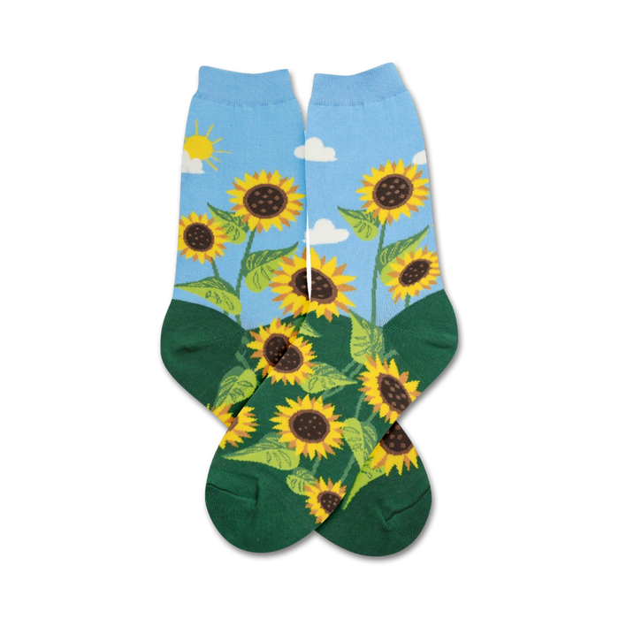 yellow sunflower socks with green leaves. white clouds, a yellow sun on a blue background. green toe and heel. crew length socks for women.  }}