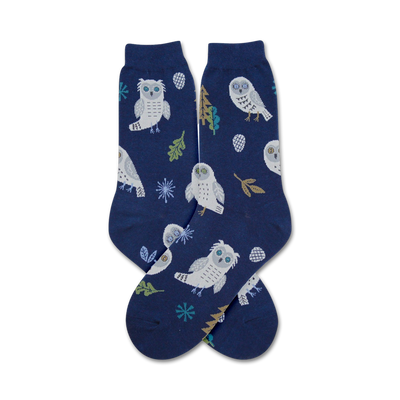 owl themed snowy blue crew socks with white, yellow, brown, and green snowy owl, pine cone, snowflake, and leaf pattern  