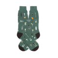 Green crew socks patterned with small bar tools, mixed drinks, and the text cocktail snob. Features dark heels and toes.
