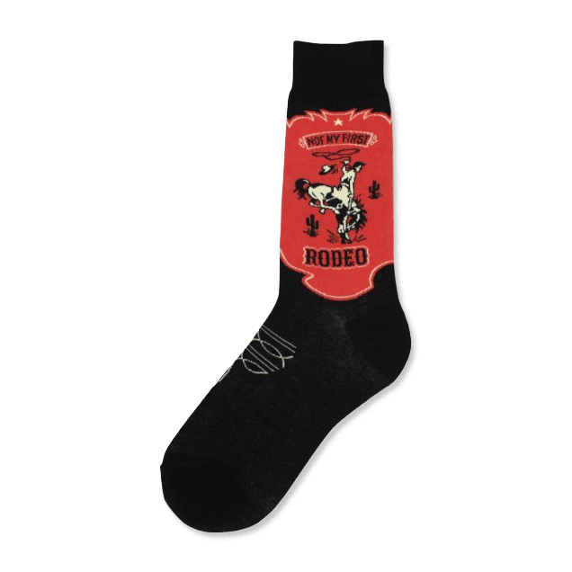 Black crew socks with a red and off-white design. The design is a vintage-style rodeo scene with a cowboy on a bucking bronco, cacti, and the text 'Not My First Rodeo'.