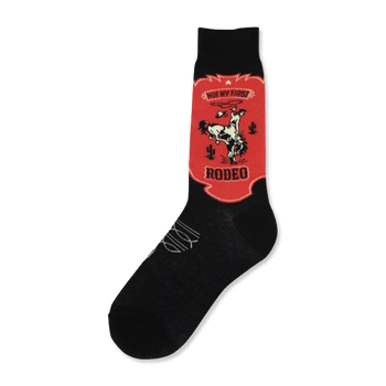 Black crew socks with a red and off-white design. The design is a vintage-style rodeo scene with a cowboy on a bucking bronco, cacti, and the text 'Not My First Rodeo'.