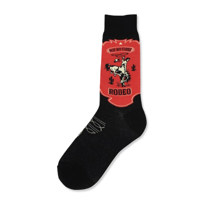 Black crew socks with a red and off-white design. The design is a vintage-style rodeo scene with a cowboy on a bucking bronco, cacti, and the text 'Not My First Rodeo'.