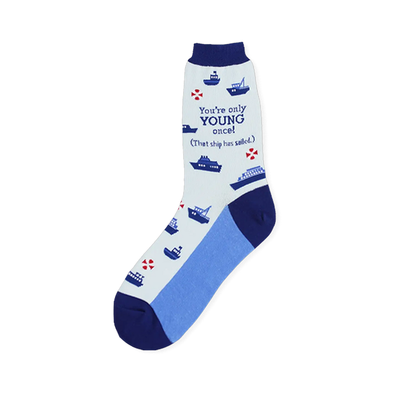 Light blue sock featuring navy boats, red life rings, and the text You're only YOUNG once That ship has sailed.