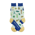 Pair of light blue crew socks with a travel theme. Features landmarks, suitcases, and a compass in navy and gold.