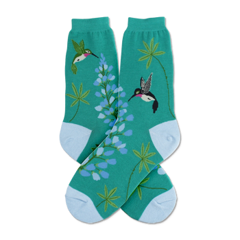 Crew socks in teal green, featuring colorful hummingbirds and lupine flowers. Light blue cuffs add a touch of contrast.