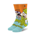 A pair of light blue crew socks featuring Tommy and Chuckie from Rugrats in a colorful cartoon design on an orange background.