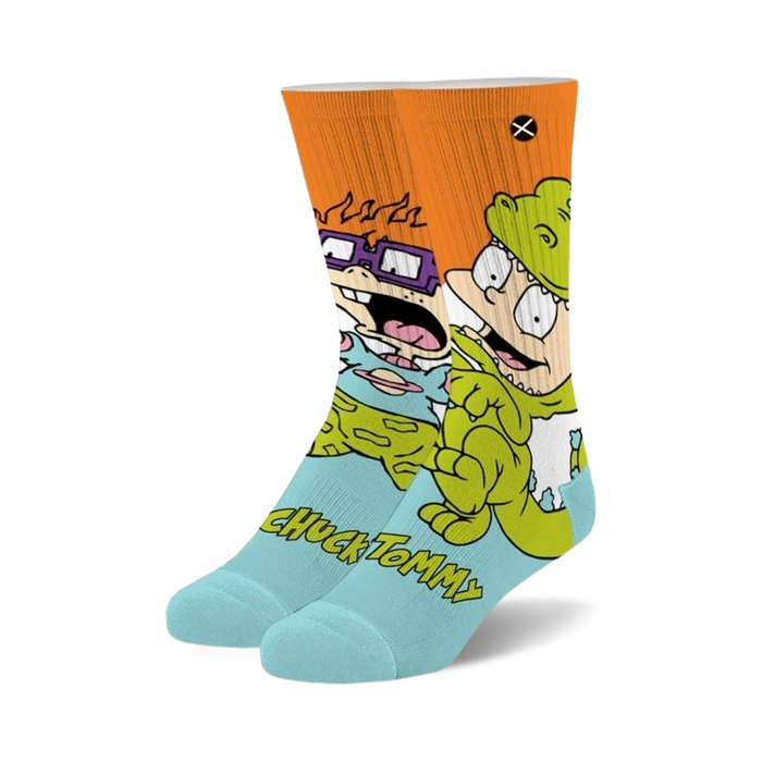 light blue crew socks with orange cuff feature repeating pattern of tommy and chuckie from rugrats.    }}