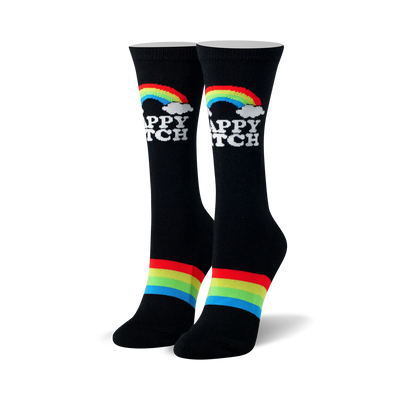 sassy "happy bitch" socks in black with cheerful white text, surrounded by rainbows and clouds. black toe and heel with rainbow ankle stripe. crew length, designed for women.   