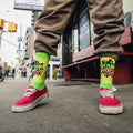 Lifestyle shot of person wearing Sour Patch Kids socks with red Vans shoes. [lf]