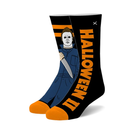 black crew socks with orange toe and heel featuring a pattern of michael myers from the halloween movies.   