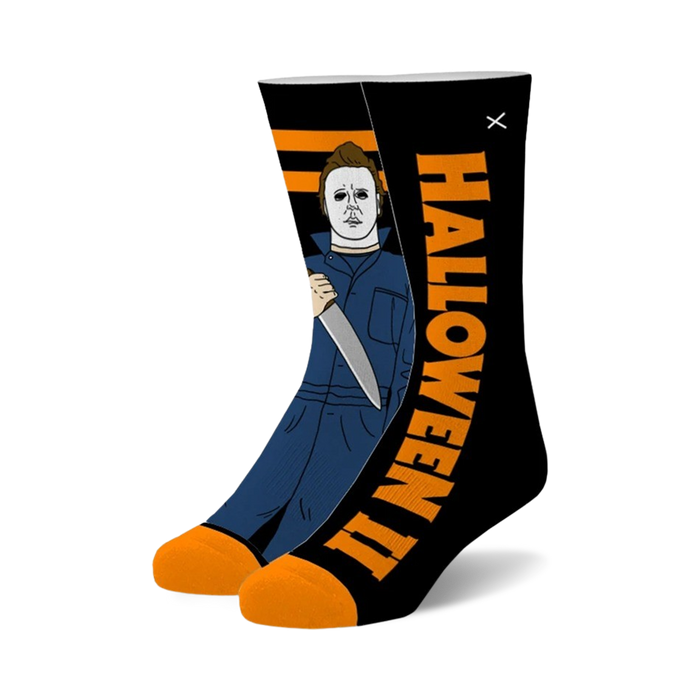 black crew socks with orange toe and heel featuring a pattern of michael myers from the halloween movies.    }}