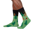 Lifestyle shot showing Sasquatch Camp Out socks on a person's legs, showcasing the design from a slightly different angle.